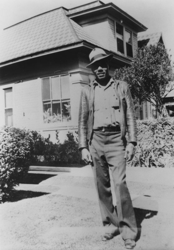 Raymond Austin in front of home